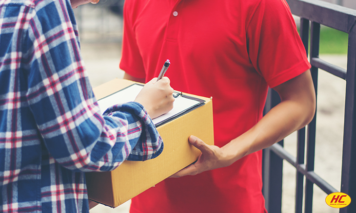logistics company employee delivering a parcel 